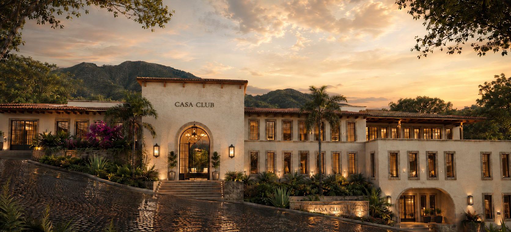 Render de la fachada de la Casa Club al atardecer, con muros de estuco, teja de barro y un acceso en arco, y las montañas al fondo