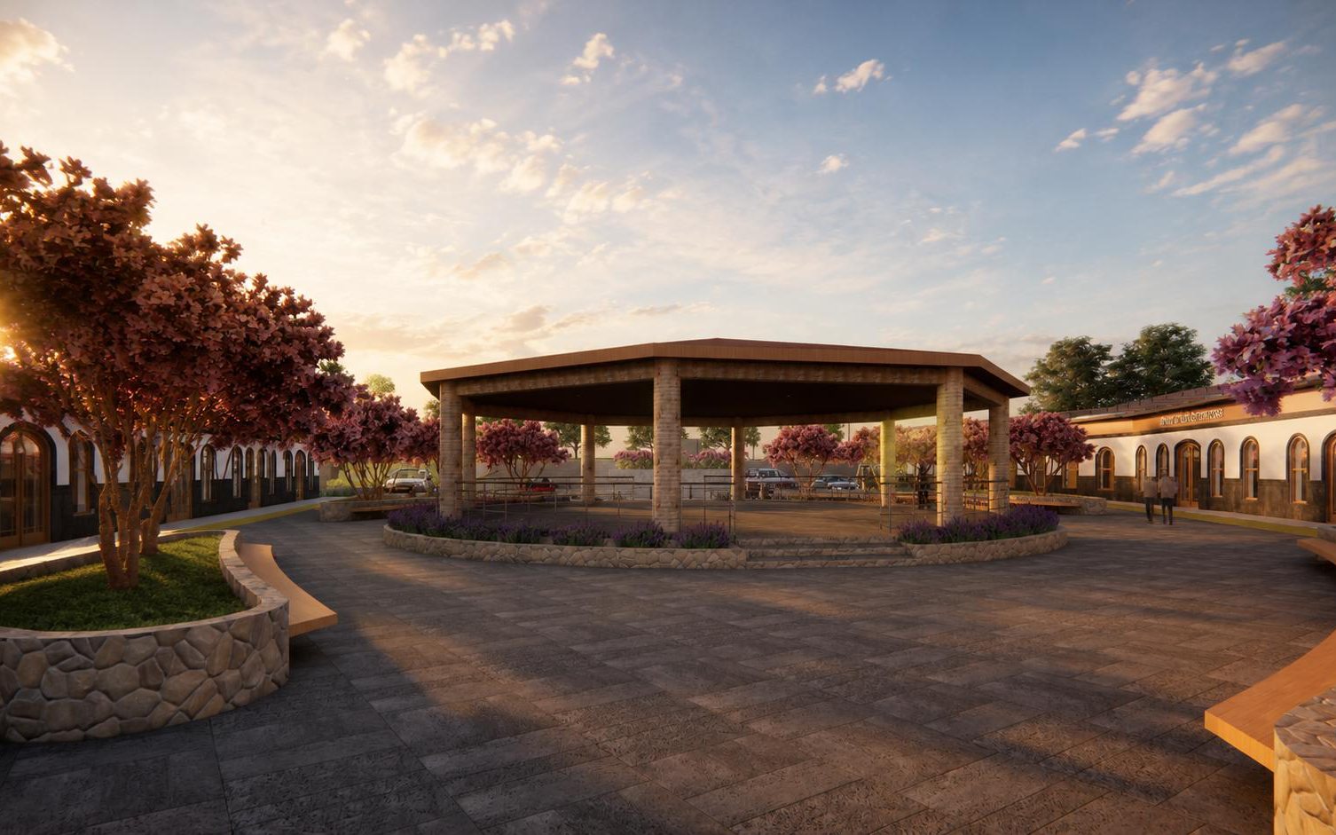 Render de la plaza comercial al atardecer, con una pérgola de madera al centro, árboles en flor y portales con arcos